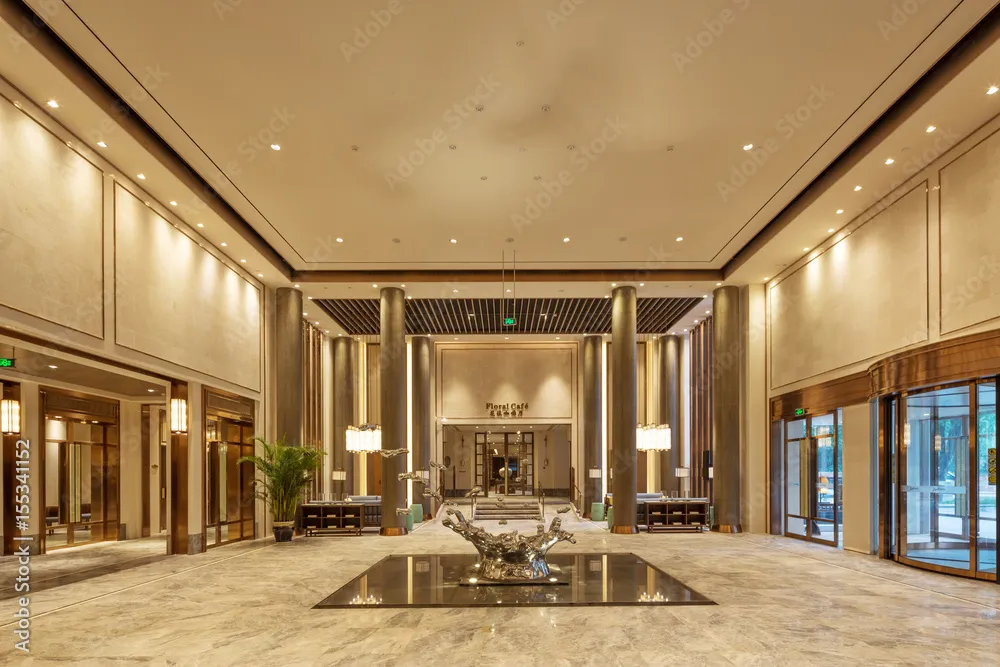 Spacious luxury hotel lobby with reception and guest areas, representing hospitality environments and integrated communications.