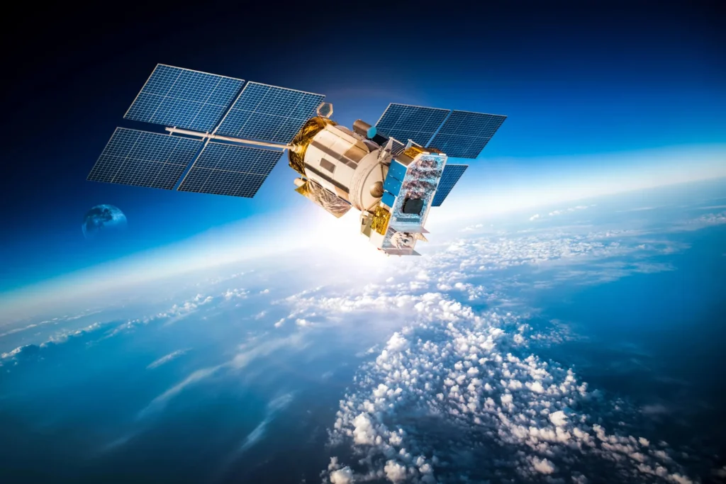 Satellite with solar panels orbiting above Earth, representing satellite communications and remote monitoring technology.