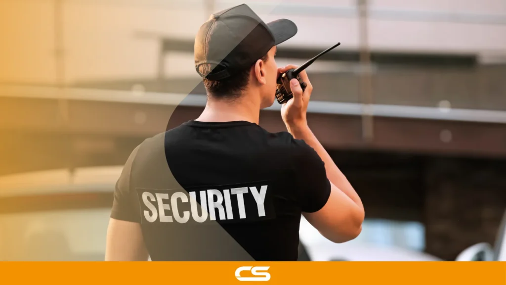 Security officer using a two-way radio to communicate while monitoring a site.